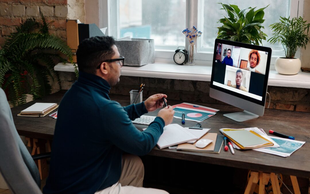 teacher-video-calling-with-his-students-using-a-computer
